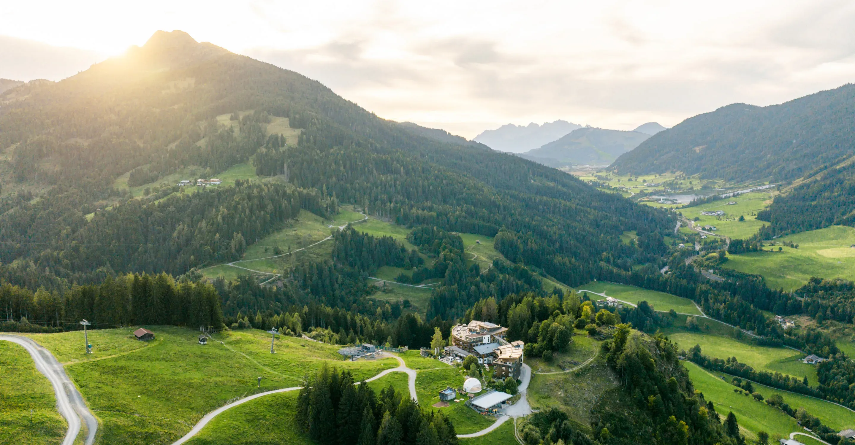 Landschaftsaufnahme mit Bergen und einem Bauernhof